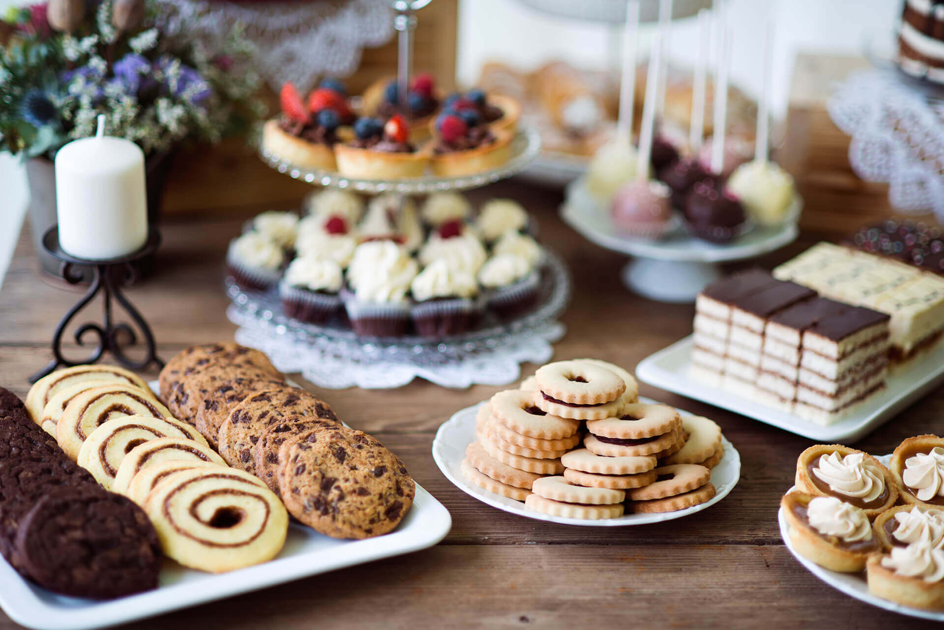 table-with-various-cookies-tarts-cakesxc-cupcakes-an-PARM8L9